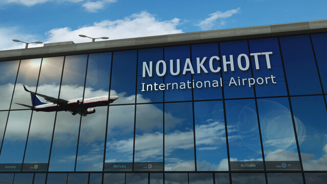 Airplane landing at Nouakchott Mauritania airport mirrored in terminal