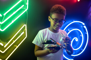Boy engrossed in a game with a toy helicopter