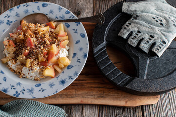Fitness breakfast with cottage cheese, cooked apples, roasted hazelnuts and linseeds
