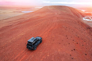 Lifeless landscape mountains Altai Republic Russia with expedition car, texture of red sand in Mars valley, aerial top view