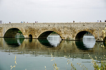 Fototapeta premium 14 May 2022 Adana Turkey. Rock bridge on Seyhan River at Adana Turkey on a cloudy day