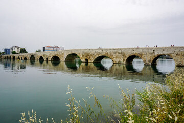 Fototapeta na wymiar 14 May 2022 Adana Turkey. Rock bridge on Seyhan River at Adana Turkey on a cloudy day