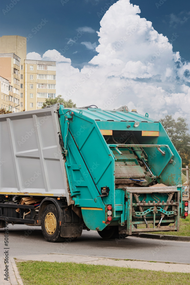 Aufkleber A garbage truck picks up garbage in a residential area. Loading mussar in containers into the car. Separate collection and disposal of garbage. Garbage collection vehicle.
