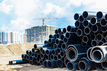 Water pipes for drinking water supply lie on the construction site. Preparation for earthworks for...