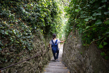 Naklejka na ściany i meble Men walking down old stone steps in Portofino