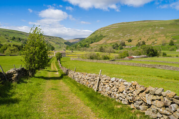 On the Coast to Coast long distance footpath walk at Muker in Swaledale in the Yorkshire Dales