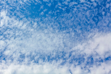 Blue sky with chemical clouds chemtrails on sunny day Germany.