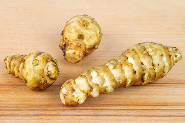 Jerusalem artichoke isolated on wooden background