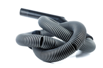 Old broken vacuum cleaner hose isolated on a white background