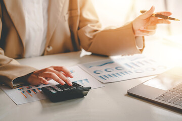 business woman or accountant who are using a calculator to calculate business data Accounting...