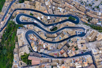 Aerial view of the old town of Ragusa Ibla and a winding road. View from above of the city in Ragusa Ibla, Province of Ragusa, Val di Noto, Sicily, Italy.