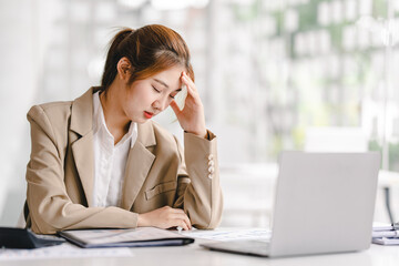feeling tired and stressed Irritated young woman closing her eyes while working at the office