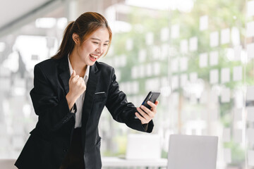 Young businesswoman is excited about Achieved sales target.