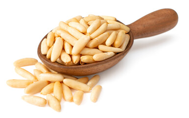 Roasted pine nuts in the wooden spoon, isolated on white background.