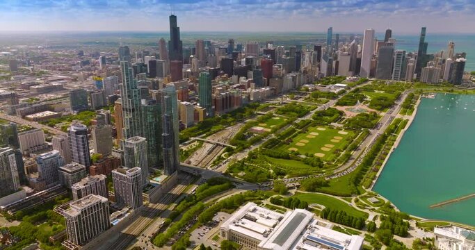 Huge green park surrounded by the beautiful skyscrapers. Aerial perspective on the spectacular scenery of Chicago city.