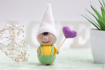 A little gnome knitted with knitting needles. Gift for children holiday card