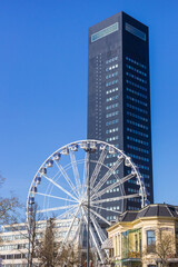 Ferris wheel in front of a scyscraper in Leeuwarden, Netherlands