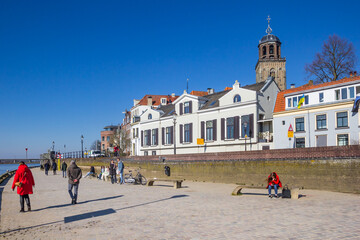Naklejka premium People walking the promenade along the IJssel river in Deventer, Netherlands