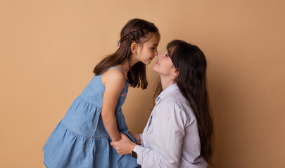 Happy mother and daughter kissing. Concept of happy family, mother's day, 8 march, birthday