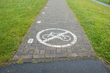 Stone footpath with a sign painted on it forbidding cycling. Security concept. 