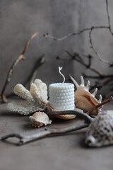 Handmade soy bubble candle on gray table with nautical decor. Natural vegetable wax.