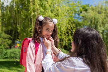 Fototapeta premium Child going back to school. Mother and kid getting ready for first school day after vacation