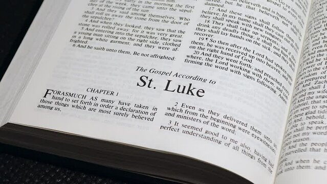 Close Up Shot of  Bible Page Turning to the book of Luke