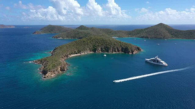 Aerial - British Virgin Islands - Drone shot of Normand Island - flying forward as a boat passes by. 