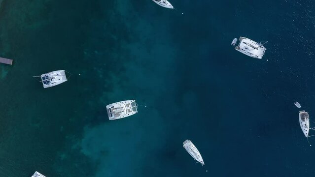 Aerial: Anchored Yachts in the British Virgin Islands. Drone flyover looking down.