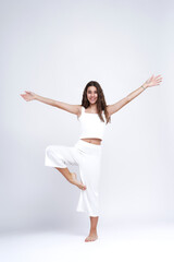 Young beautiful girl doing yoga poses, studio white background