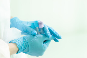 a nurse holds empty test tubes in two hands