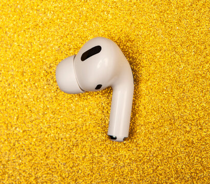 image of earphones gold background