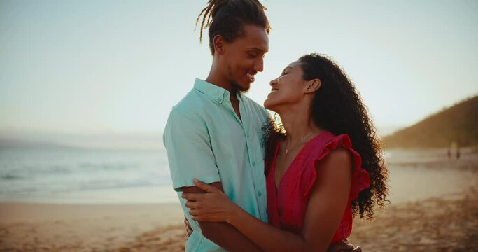 Romantic happy young black couple in love on the beach at sunset on vacation