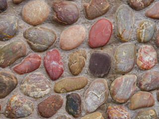 Old cobblestone road with soil between stones. Texture and background.