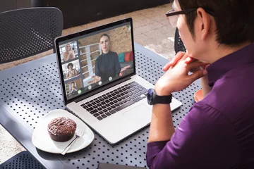 Keuken foto achterwand Aziatische plekken Aziatische zakenman die laptop in café gebruikt tijdens videoconferentie met multiraciale collega& 39 s