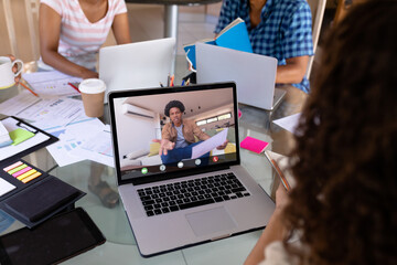 African american angry businessman on video call talking to biracial female colleague in office