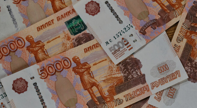 Largest bill of Bank of Russia. Russian paper banknotes with nominal value of five thousand rubles close-up view from above. Economics and finance of Russian Federation.
