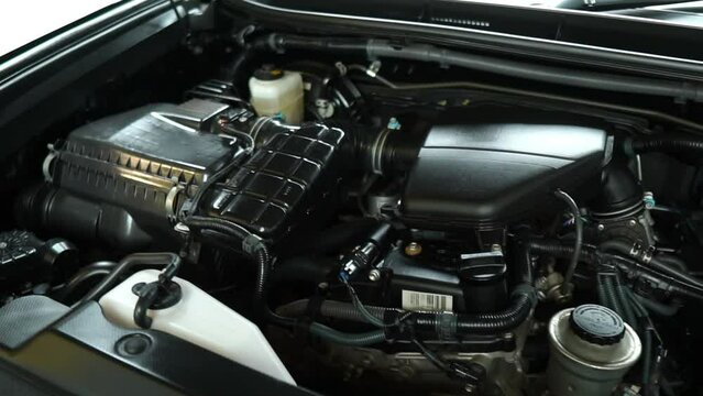 Top shot of open barnet showing the engine of the black Land cruiser. Toyota Land Cruiser Prado, Close up of a clean motor block. Internal combustion engine,