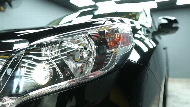 Close up shot of Fortuner cruise headlight blinking.