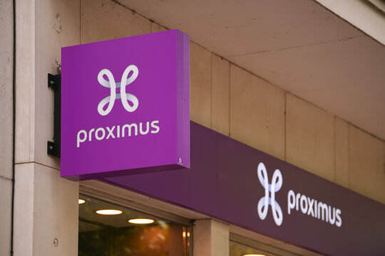 The logo sign of Proximus, largest of Belgium mobile telecommunications company, on top of a store. Brussels, 2022.