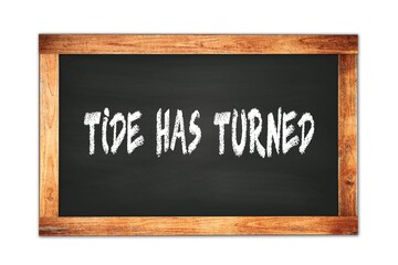 TIDE  HAS  TURNED text written on wooden frame school blackboard.