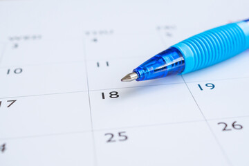 Blue pen on calendar page background business planning appointment meeting concept
