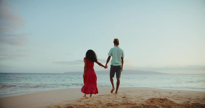 Beautiful Aspirational Young Couple Enjoying Romantic Sunset Walk On The Beach On Vacation