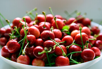 red cherries in white bowl