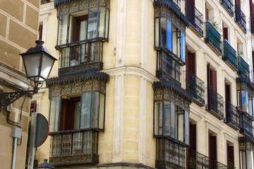 Fototapeta na wymiar Decadent retro facade with vintage balconies and windows downtown Madrid, Spain