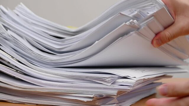 Businessman are searching for documents lying on the table, business report papers, important documents.