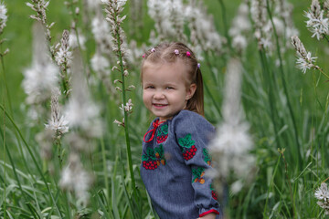 Caucasian litle girl in wildflower meadow