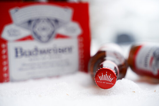 Marinette,WI,USA -Dec1-2021: An outdoor vendor sells Budweiser beer chilled on a table with lots of Snow. Bottles of Bud beer, an American-style pale lager produced by Anheuser-Busch.