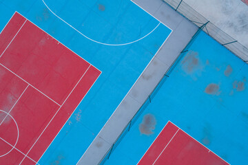 Aerial view of a red and blue futsal and tennis courts, racket sports