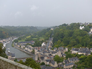 Fototapeta na wymiar Dinan, France - August 2018 : Visit the beautiful city of Dinan in Brittany, through the fortifications and through the city 